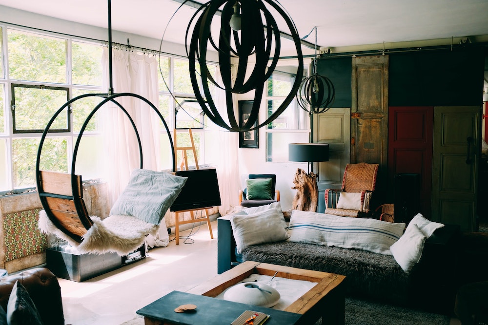 Textile Touches hanging chair and couch topped with comfy blankets and textiles