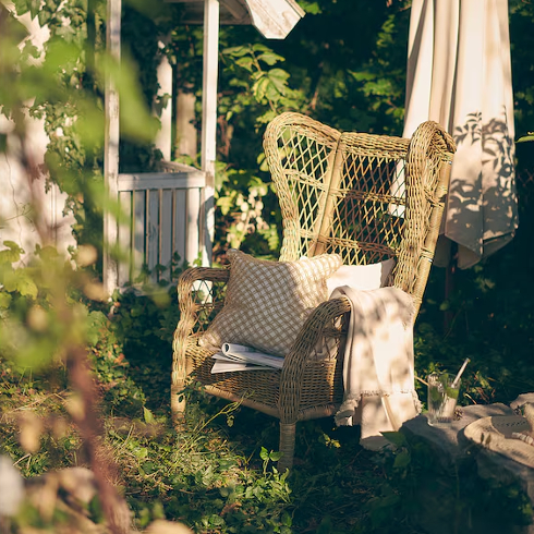 Wonderful Wicker The RISHOLMEN Wicker chair from IKEA in a lush green backyard
