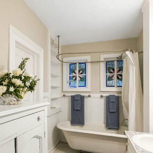 Shower Curtains A white bathroom with a clawfoot tub and white shower curtain