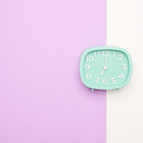You’re Focused on the Time A blue clock on a purple and white background