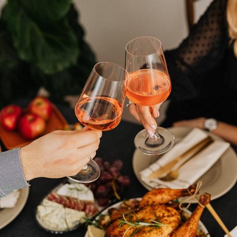 You Leave Guests’ Glasses Empty Toasting with wine at a dinner table