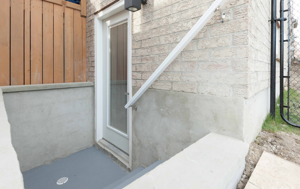 Separate Entrance Basement entrance leading down a few stairs.