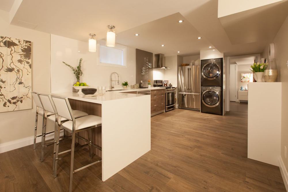 Separate Laundry Basement apartment featuring a laundry unit in the kitchen.
