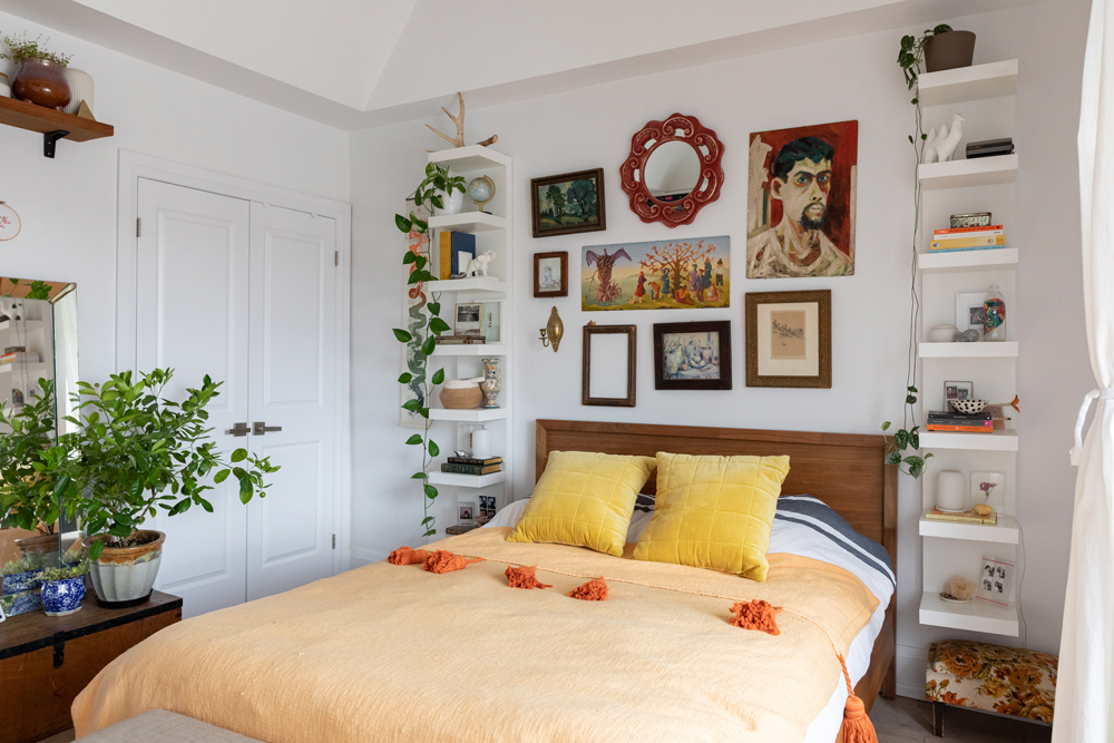 Shelves on Shelves on Shelves white bedroom with two rows of shelves framing yellow bed