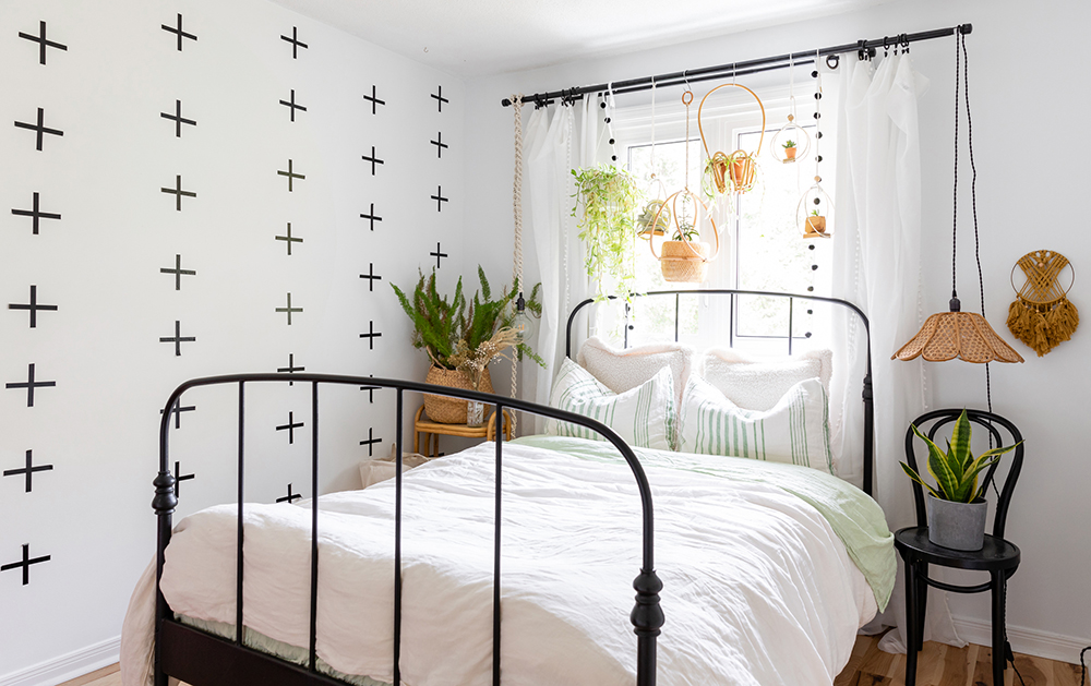 Hang Some Green boho white bedroom with row of hanging green plants above bed