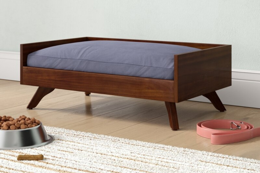 Mid-Century Modern A wooden midcentury dog bed with a blue cushion