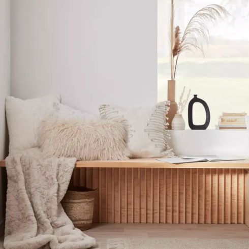 Sheep Faux Fur Throw Blanket Sheep faux fur throw blanket on wooden bench with white accent decor around