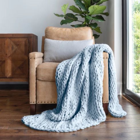 Chunky Knit Throw Chunky light blue throw blanket on light brown leather chair