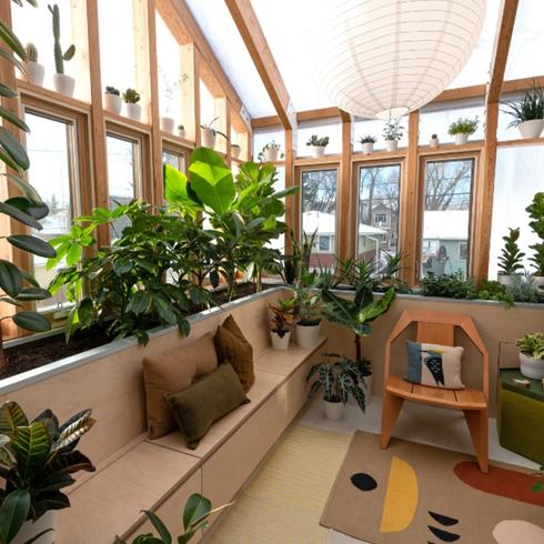 Adding a Sunroom Bright sunroom with plants