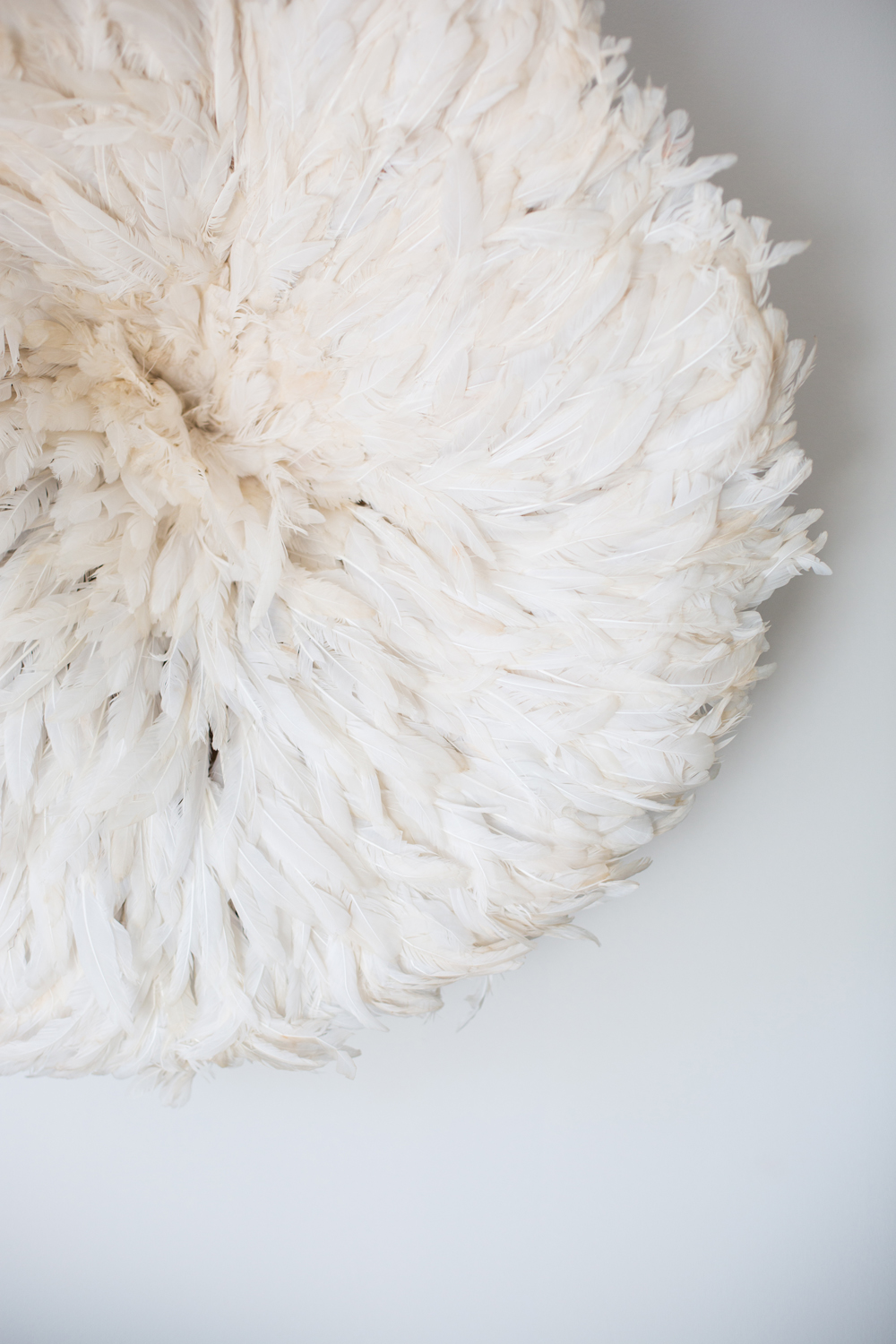 Fit for an Angel White Juju hat hung on a wall