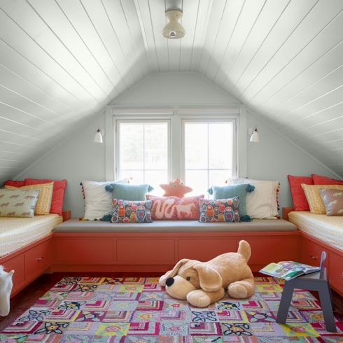 Incorporate Storage Everywhere, And Paint it a Fun Colour Kids' attic playroom with built-in toy storage benches