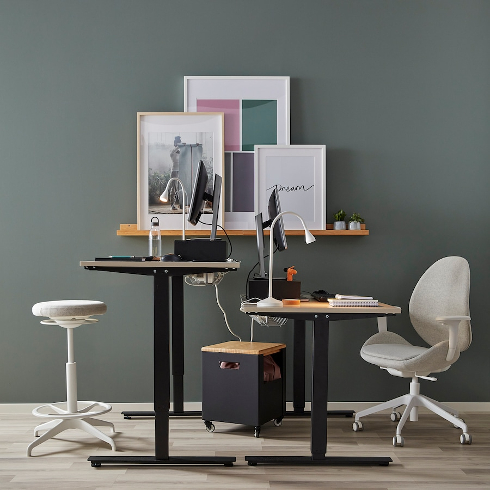 Sit and Stand Solution Two desks in a shared office, one in sit and one in stand position