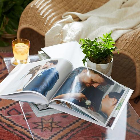 Design a Photo Book A wedding photo book displayed on a coffee table in a living room.