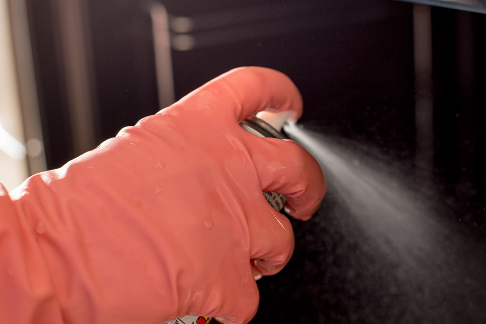 Use a Commercial Oven Cleaner Spraying oven cleaner