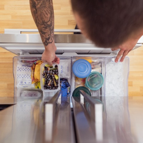 Use Divided Bins or Racks in the Freezer Compartment Person opening their freezer