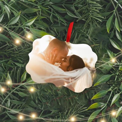 Transform a Photo into an Ornament An ornament of a couple embracing on a Christmas tree.