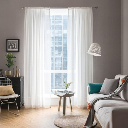 Keep It Light with Sheer Curtains French window with white sheer window curtain in a living room.