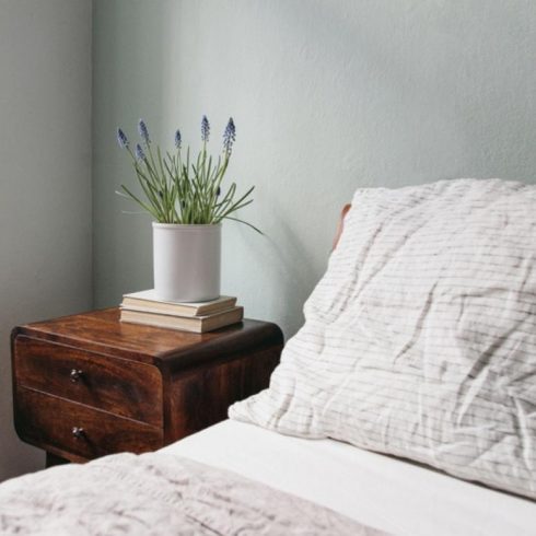 Pastel Perfect light green bedroom with wooden bed and night stand