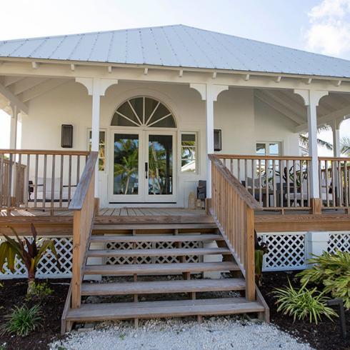 What About the Suites and Villas? Exterior of white Bahamian villa at Caerula Mar Club