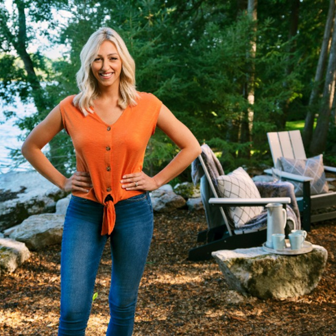 Debra Salmoni Debra Salmoni standing next to a lake and fire pit