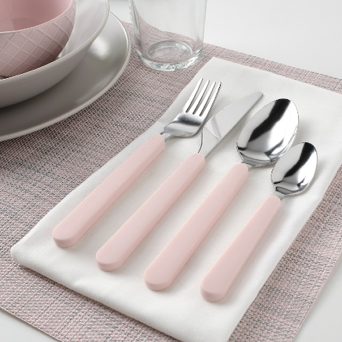 A Soft Pink Cutlery Set Silver and pink cutlery set laid out on a napkin