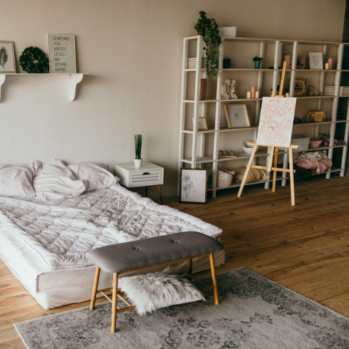 Rugs, Rugs, Rugs white bed in white bedroom with white shelving and grey rug