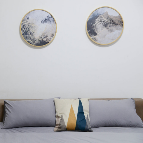 Feng Shui for the Win blue bed with headboard in light blue bedroom with round art on the walls