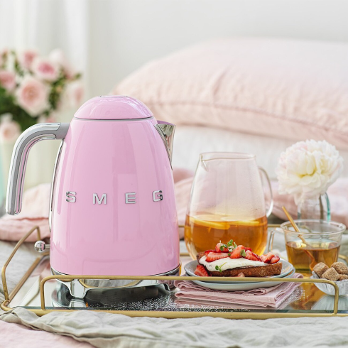 A Baby Pink Kettle A retro-style pink Smeg electric kettle on. serving tray with breakfast dishes and tea