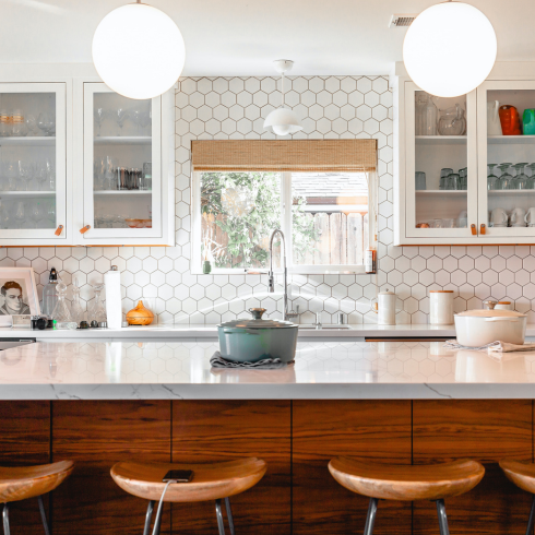 Fancy Kitchen Tile A modern kitchen island with bar stools next to it